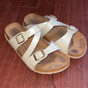 Pearl white sandals with gold buckles